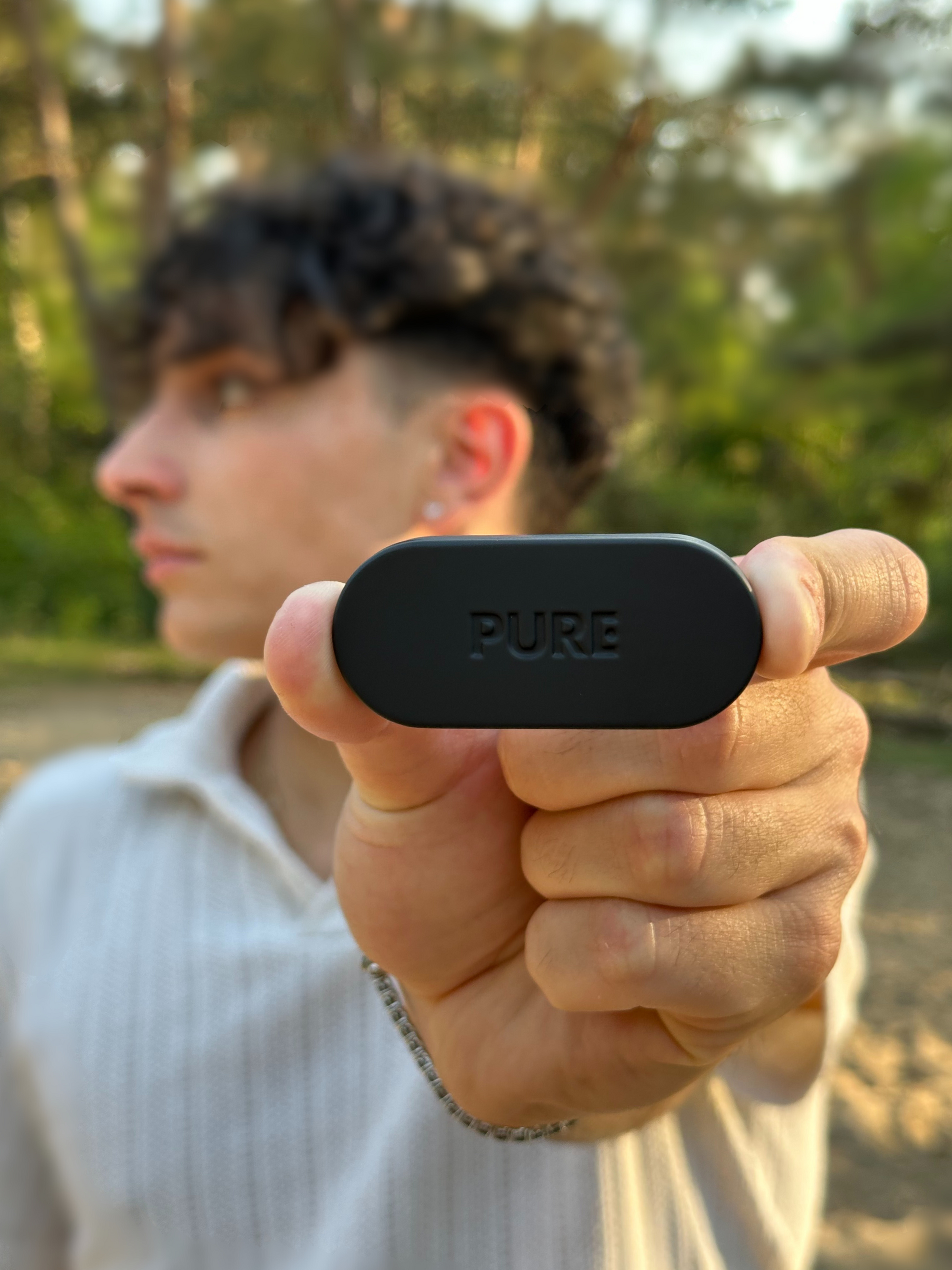 Pure solid perfume box held by a boy in de woods